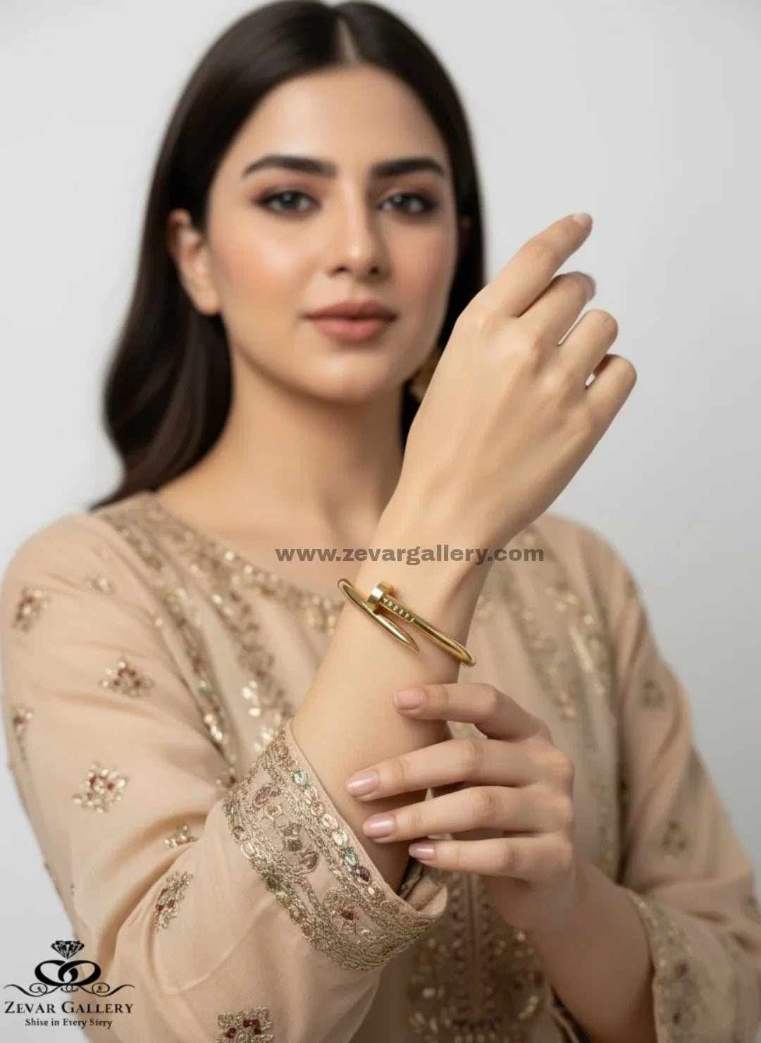 Luxury gold finish stainless steel bracelet with nail motif for women by Zevar Gallery